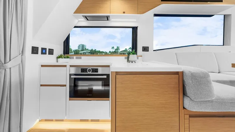  Yacht Photos Pics Modern kitchen interior of 2022 Pardo Yachts E60 with sleek cabinetry and large windows.