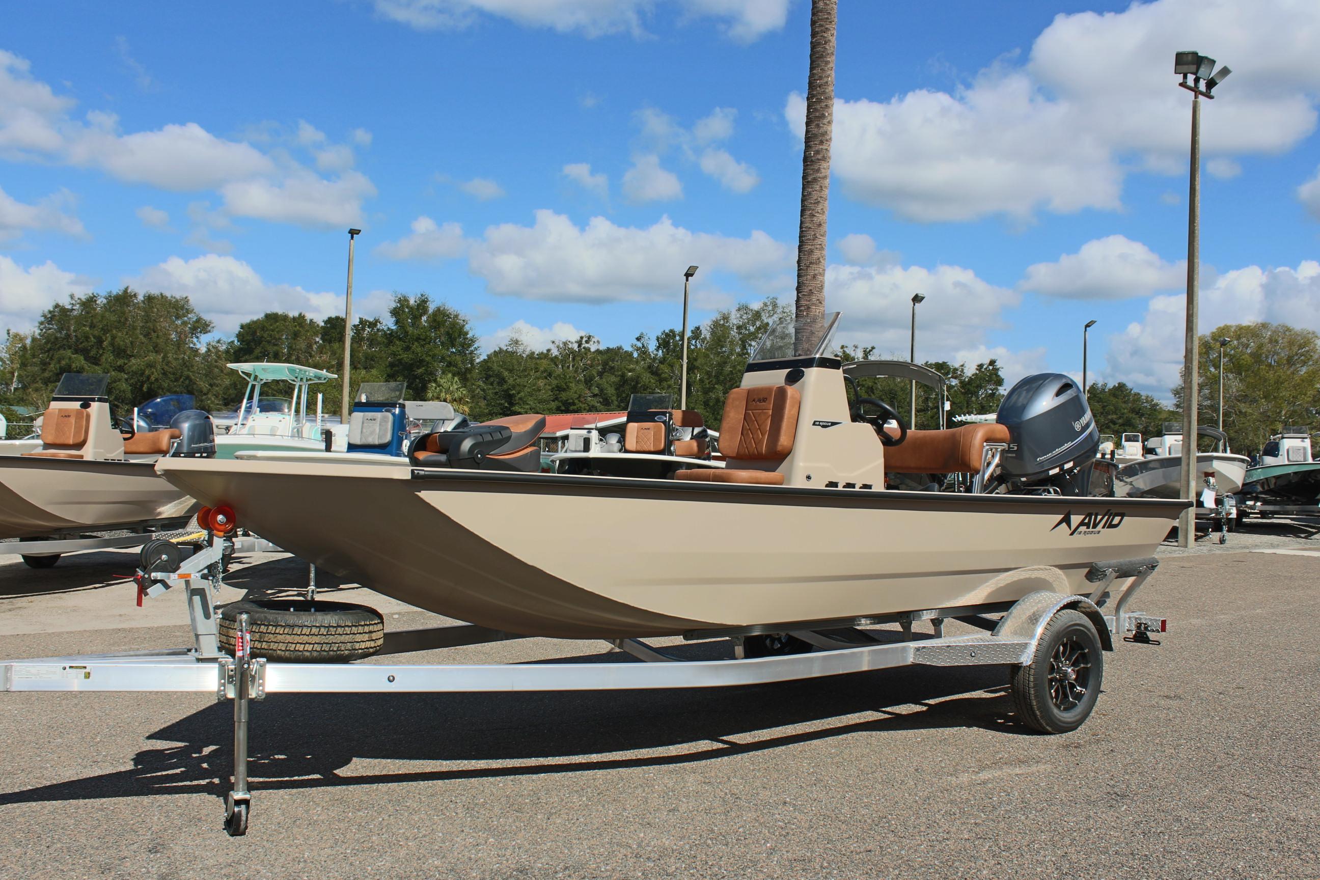 2025 Avid 18 Rogue CC boat on trailer, parked outdoors under blue sky.