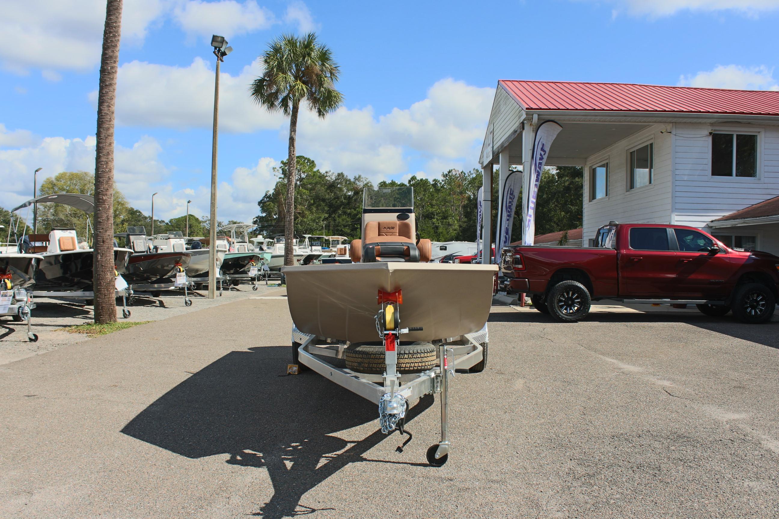 2025 Avid 18 Rogue CC boat on trailer at dealership, sunny day.