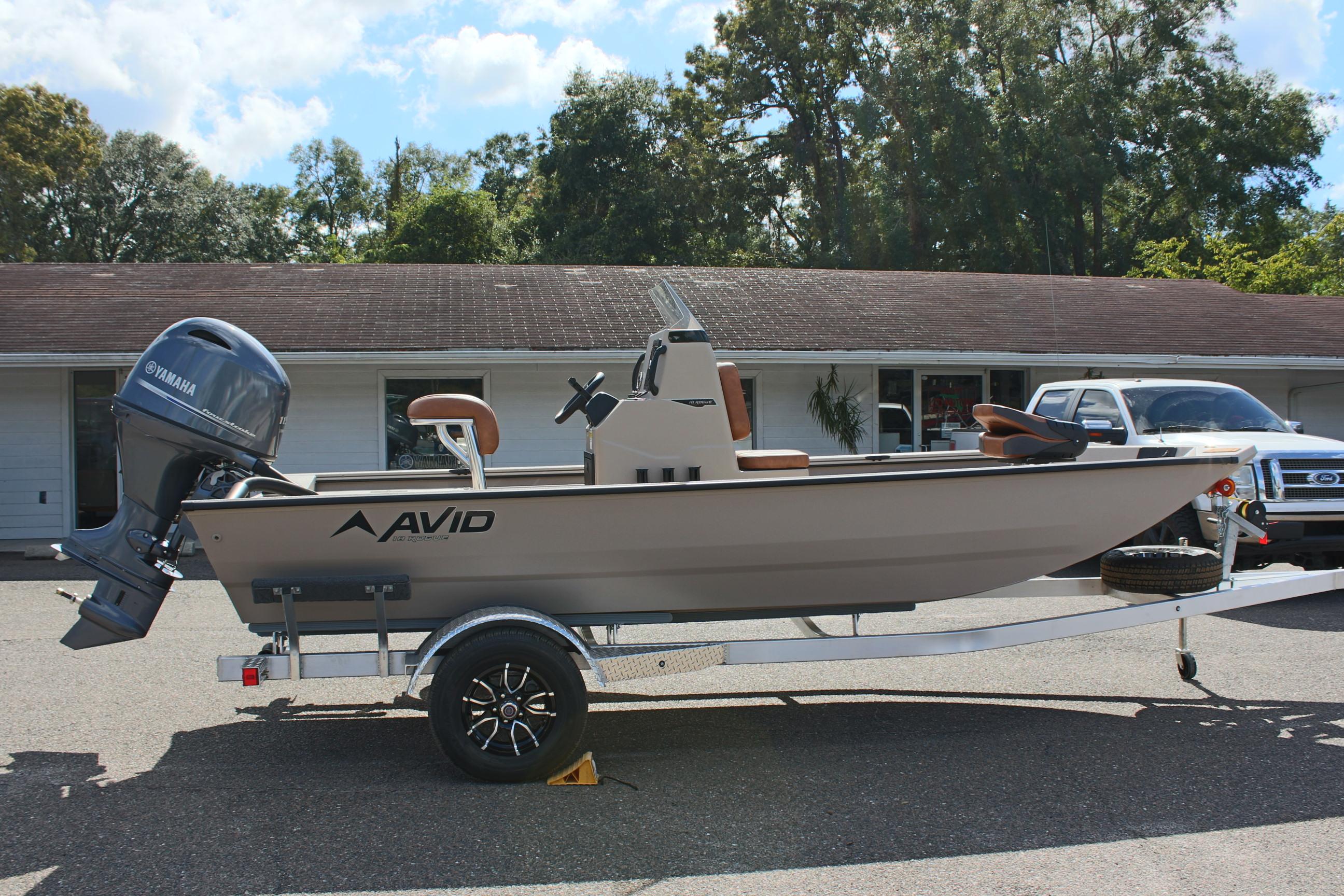 2025 Avid 18 Rogue CC boat on trailer, parked outdoors.