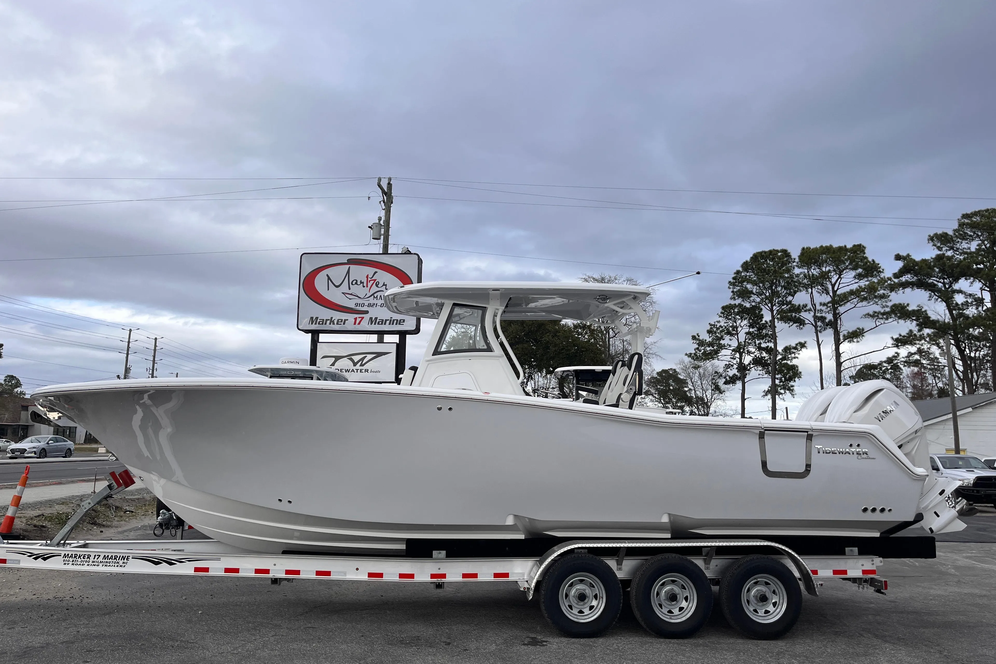 2025 Tidewater 302 CC Adventure boat on trailer, parked outdoors.