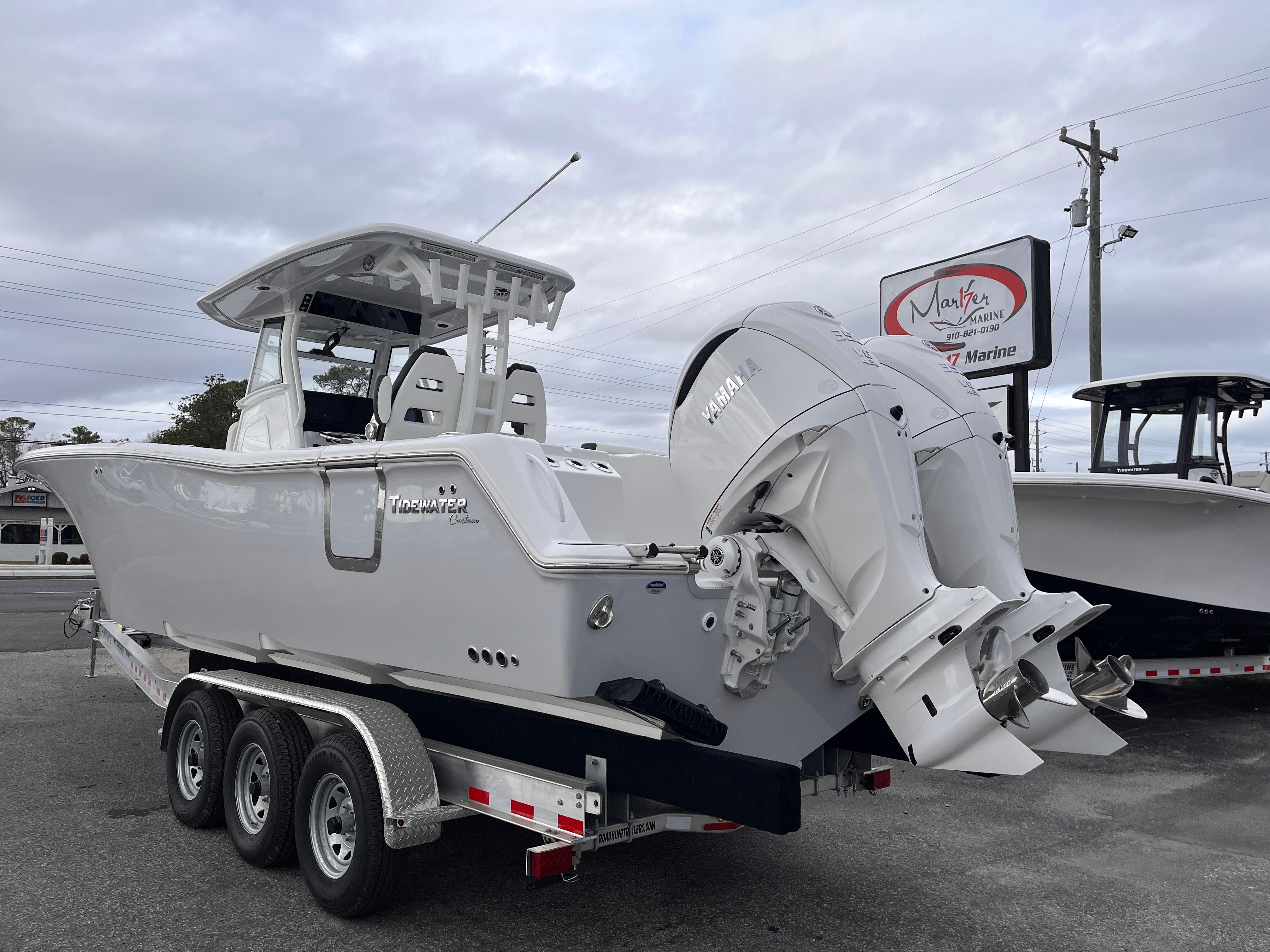 2025 Tidewater 302 CC Adventure boat on a trailer, featuring dual outboard engines.