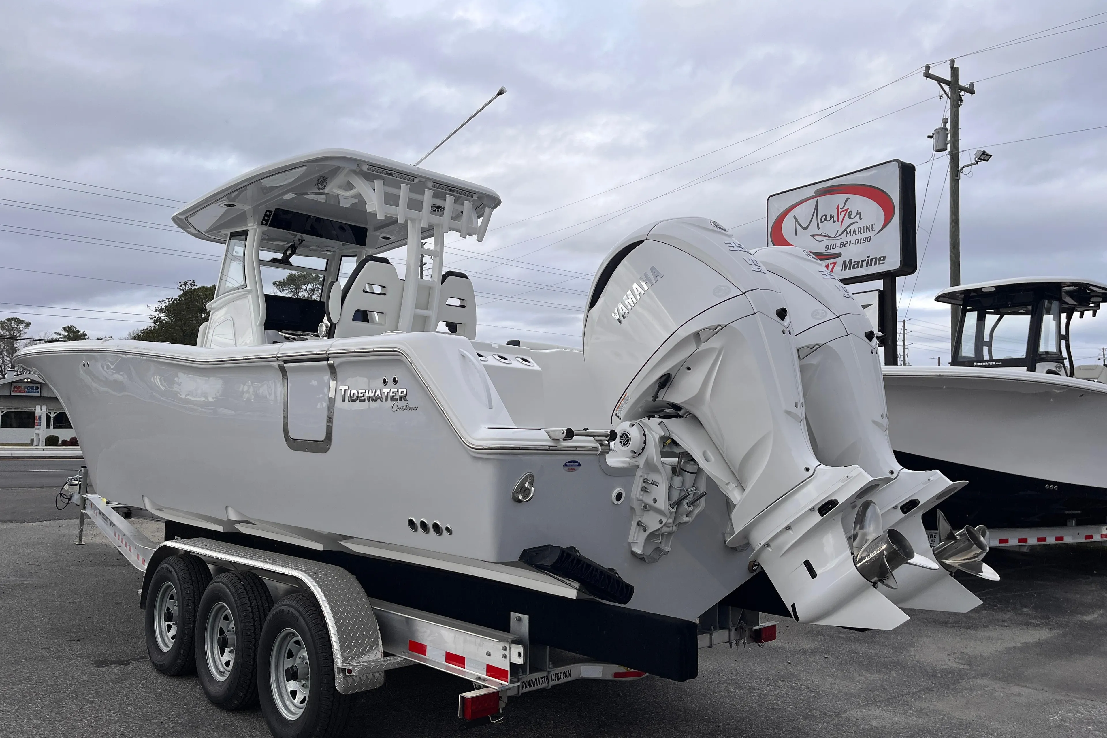 2025 Tidewater 302 CC Adventure boat on a trailer, featuring dual outboard engines.