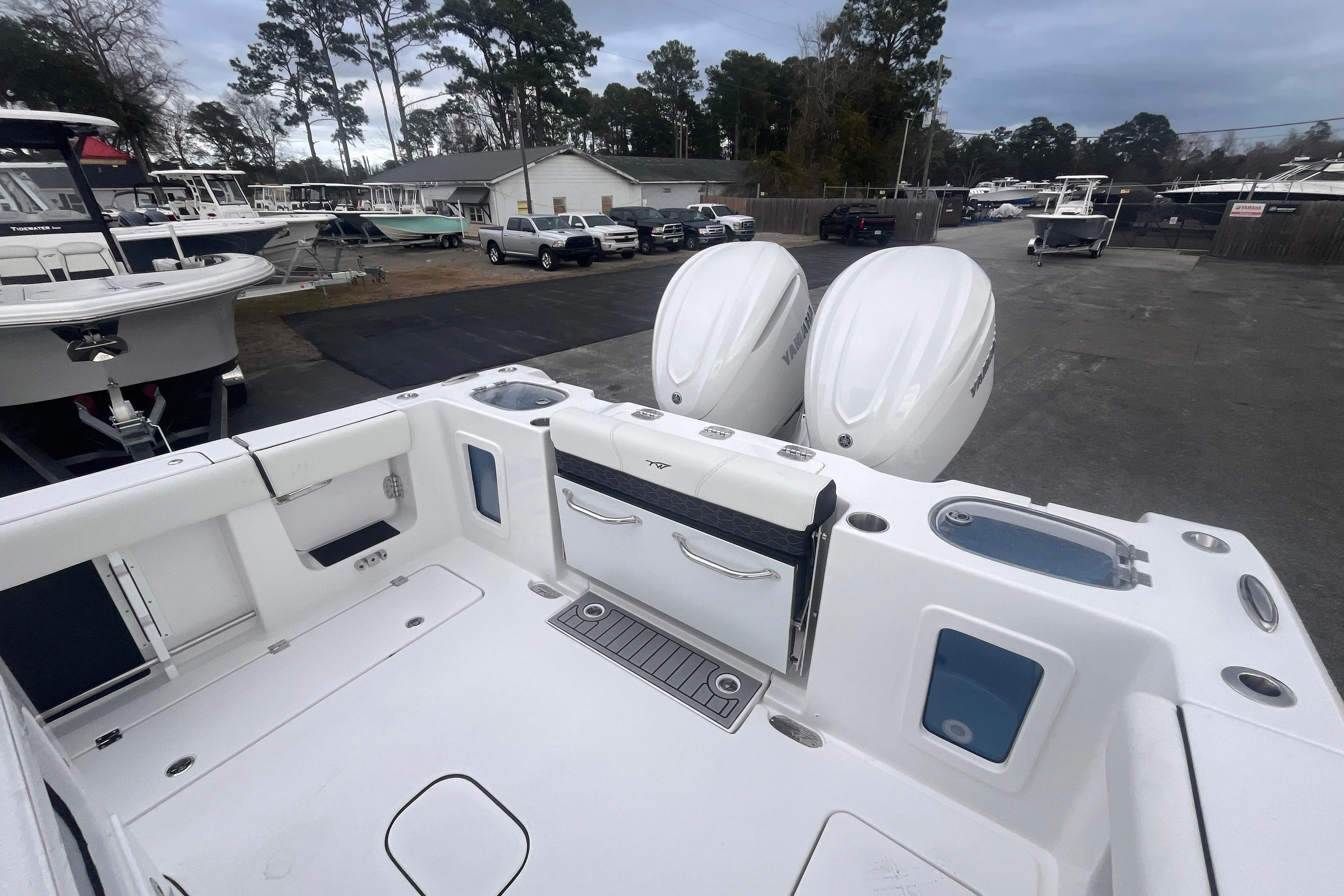 2025 Tidewater 302 CC Adventure boat with dual engines, docked in a marina.