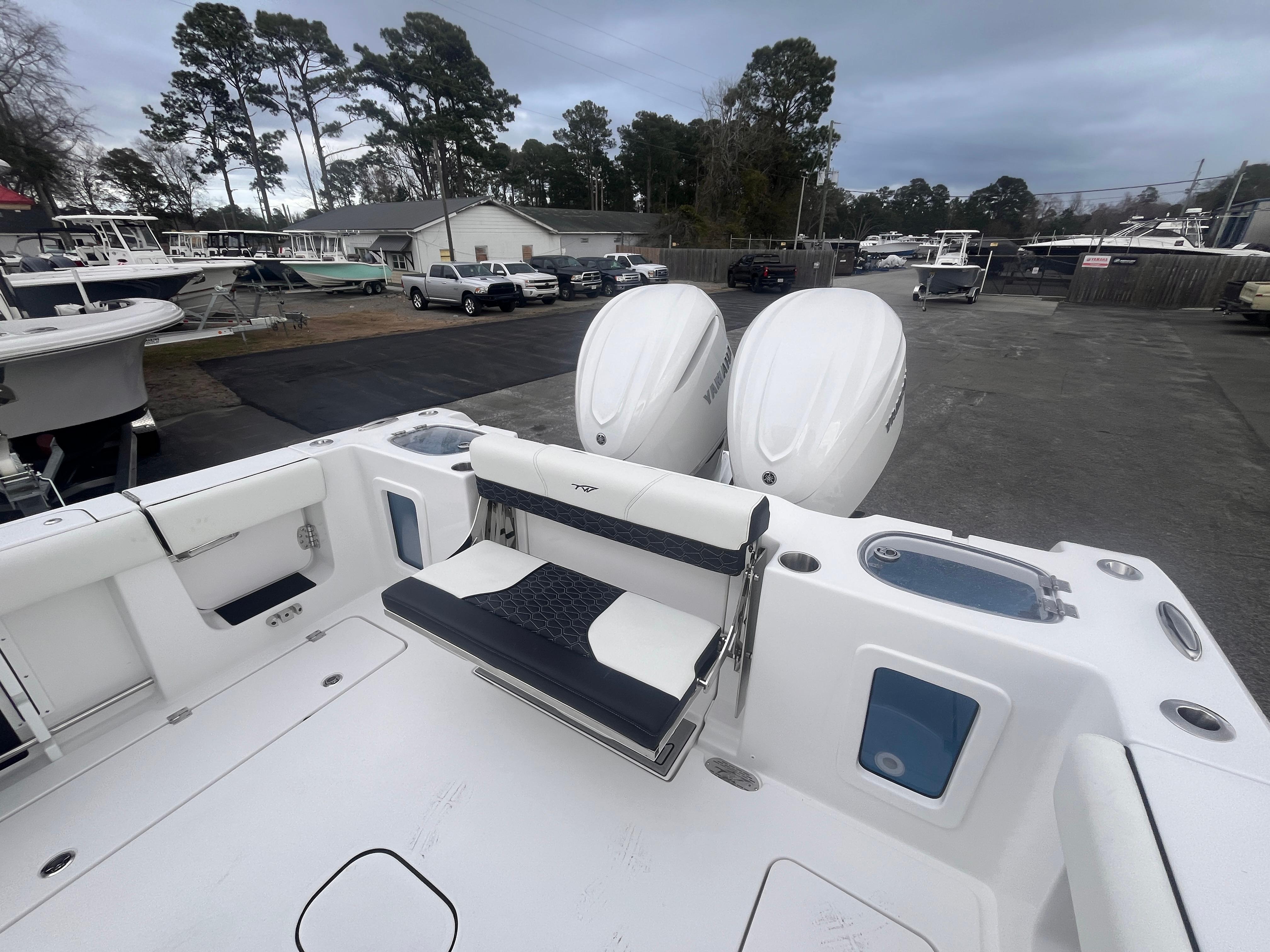 2025 Tidewater 302 CC Adventure boat with dual engines, docked in a marina.