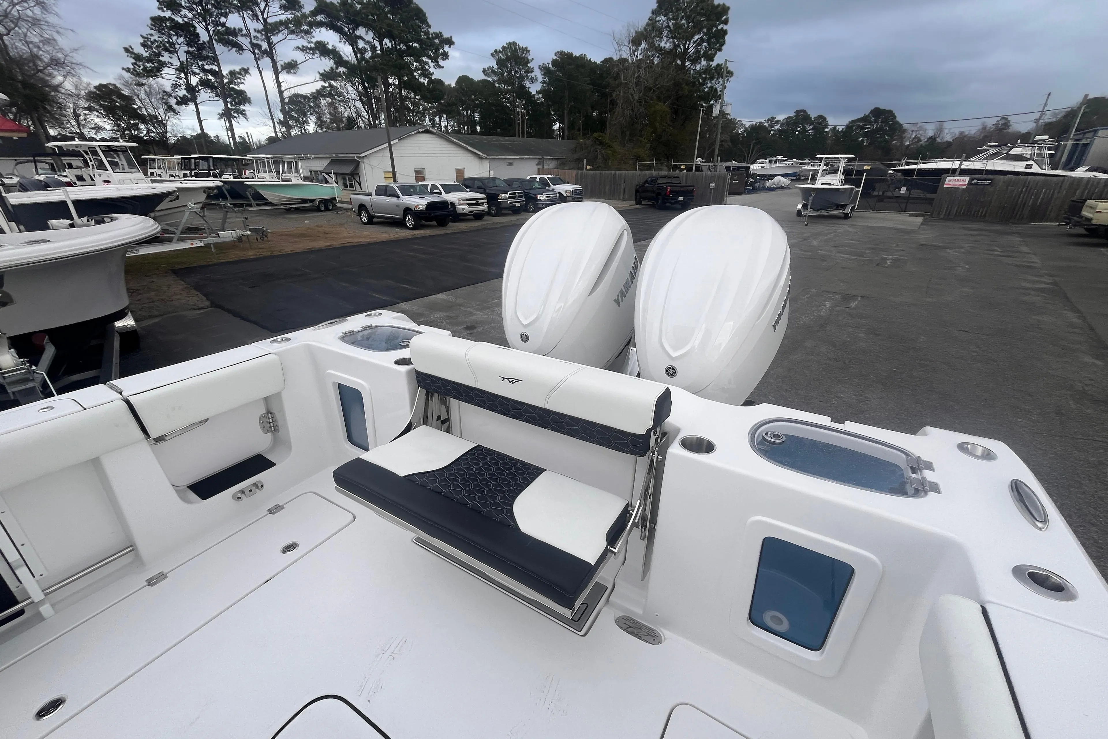 2025 Tidewater 302 CC Adventure boat with dual engines, docked in a marina.