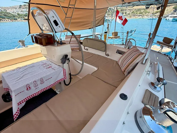  Yacht Photos Pics Luxurious 2008 Island Packet 465 yacht deck with seating, Canadian flag, and scenic ocean view.