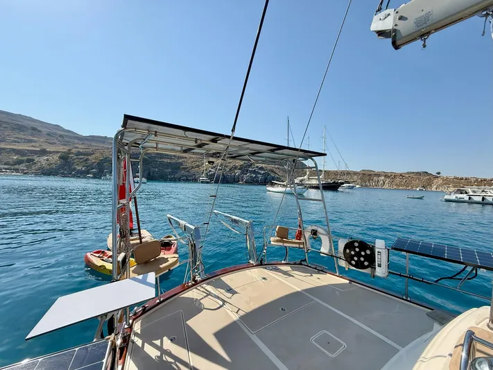  Yacht Photos Pics Sailboat Island Packet 465, 2008 model, anchored in a scenic bay with clear blue water.