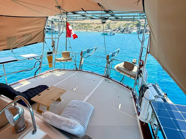  Yacht Photos Pics Luxurious 2008 Island Packet 465 yacht deck with seating, table, and ocean view.