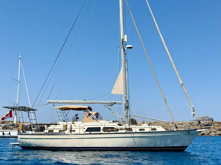 Yacht Photos Pics 2008 Island Packet 465 sailboat on calm blue water under clear sky.