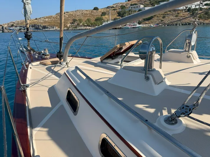  Yacht Photos Pics 2008 Island Packet 465 sailboat deck with clear blue water and scenic coastline.