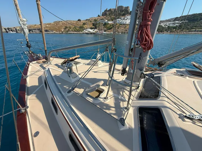  Yacht Photos Pics 2008 Island Packet 465 sailboat deck with scenic coastal backdrop.