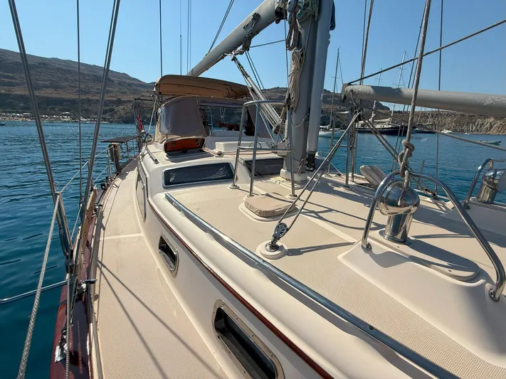  Yacht Photos Pics 2008 Island Packet 465 sailboat deck with scenic coastal backdrop.