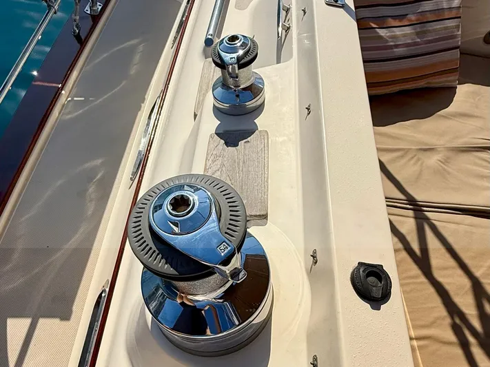  Yacht Photos Pics Winches on 2008 Island Packet 465 sailboat deck, with striped cushion in background.