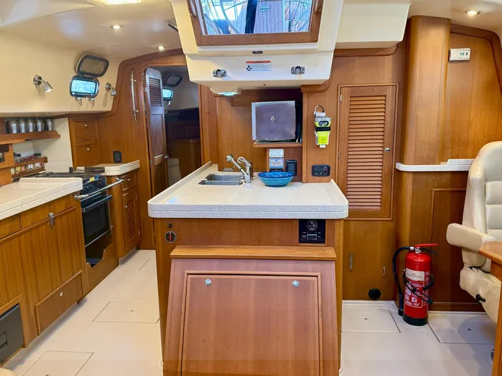  Yacht Photos Pics 2008 Island Packet 465 yacht interior with wooden cabinetry and modern kitchen amenities.