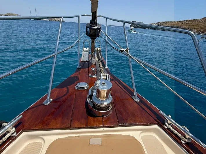  Yacht Photos Pics Bow of 2008 Island Packet 465 yacht with polished wood deck and clear blue sea.