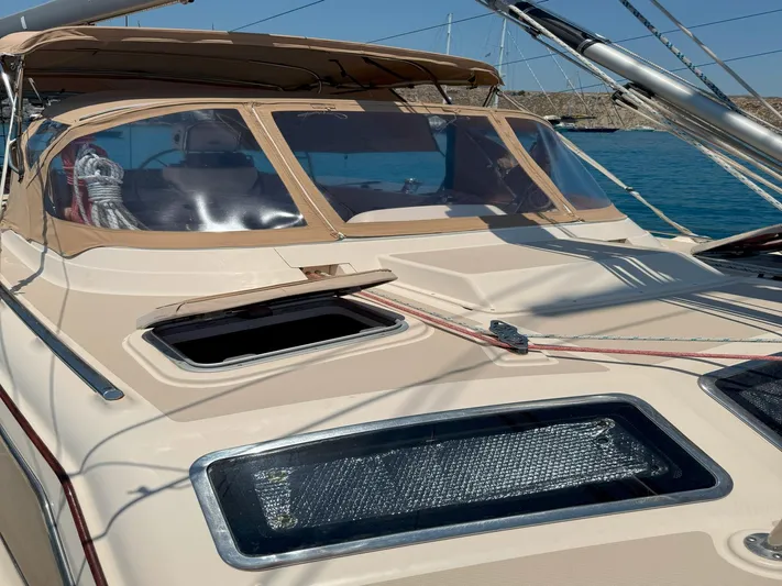  Yacht Photos Pics 2008 Island Packet 465 sailboat deck with open hatch and tan canopy.