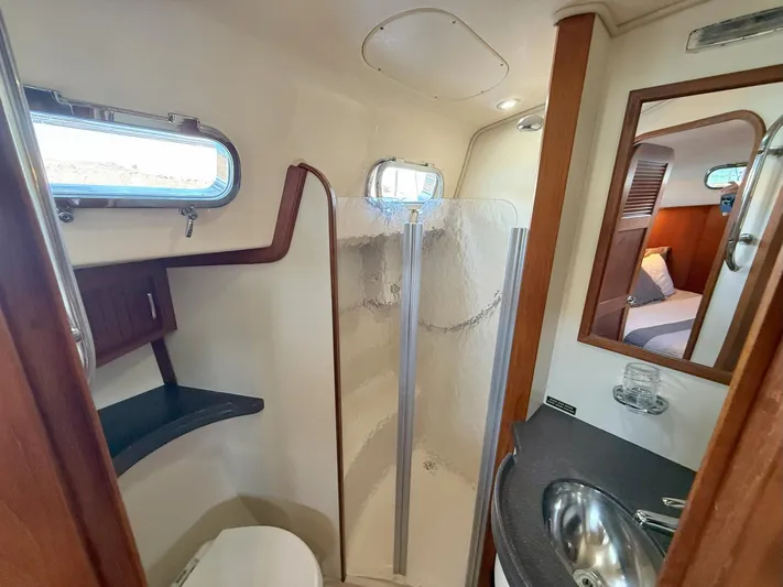  Yacht Photos Pics Luxurious bathroom in 2008 Island Packet 465 yacht with shower, sink, and porthole window.