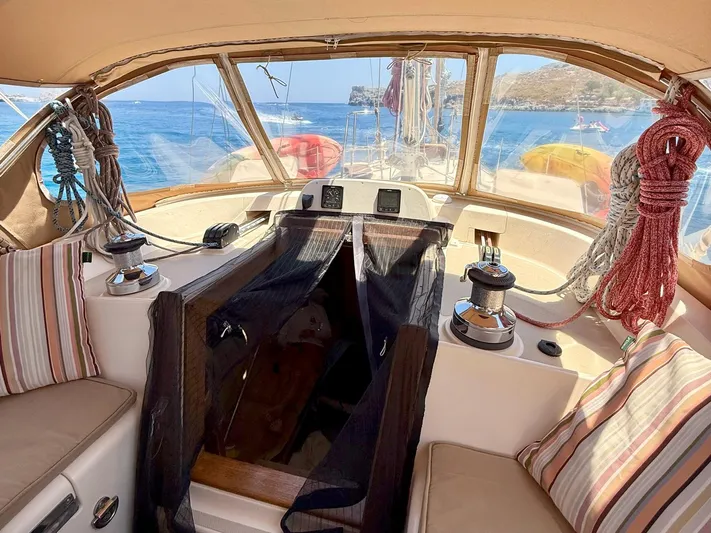  Yacht Photos Pics 2008 Island Packet 465 sailboat cockpit with ropes, winches, and striped cushions.