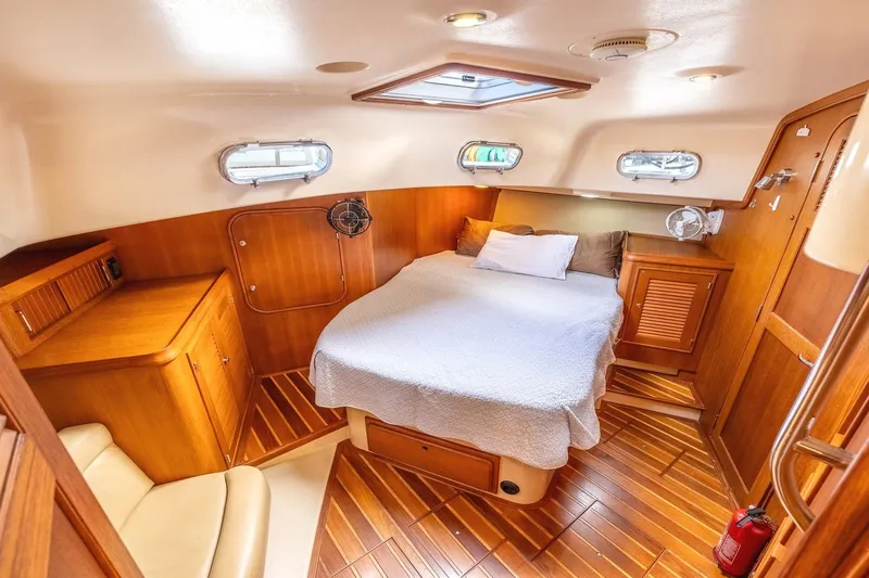  Yacht Photos Pics Luxurious 2008 Island Packet 465 yacht cabin with cozy bed and wooden interior.