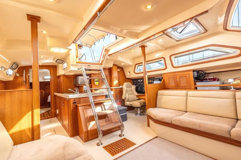  Yacht Photos Pics Luxurious interior of 2008 Island Packet 465 yacht with elegant wood finishes and plush seating.