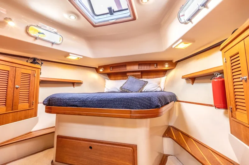  Yacht Photos Pics Luxurious cabin interior of 2008 Island Packet 465 yacht with cozy bed and wooden accents.