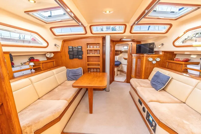  Yacht Photos Pics Luxurious interior of 2008 Island Packet 465 yacht with cozy seating and elegant wood finish.