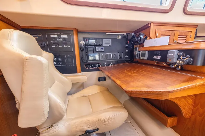  Yacht Photos Pics Luxurious 2008 Island Packet 465 yacht interior with navigation station and plush seating.