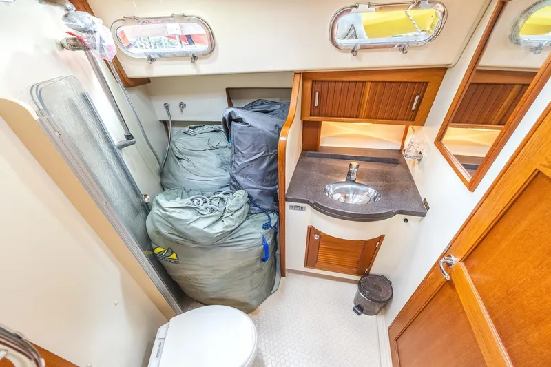  Yacht Photos Pics 2008 Island Packet 465 yacht bathroom with sink, storage, and portholes.