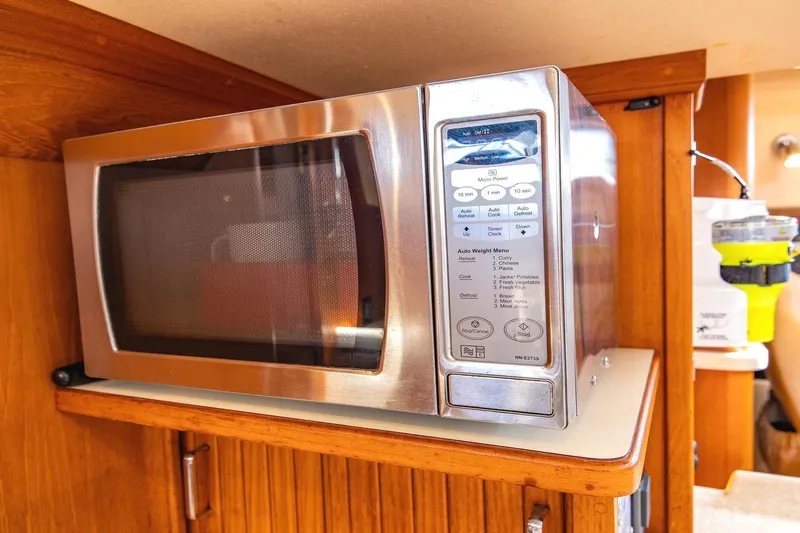  Yacht Photos Pics Microwave in 2008 Island Packet 465 yacht kitchen, wooden cabinetry, and modern design.