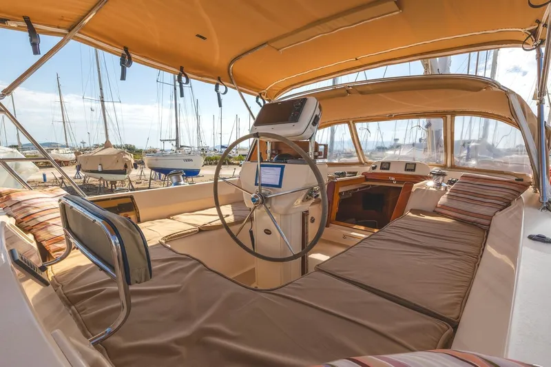  Yacht Photos Pics Interior view of 2008 Island Packet 465 sailboat cockpit with cushioned seating and steering wheel.