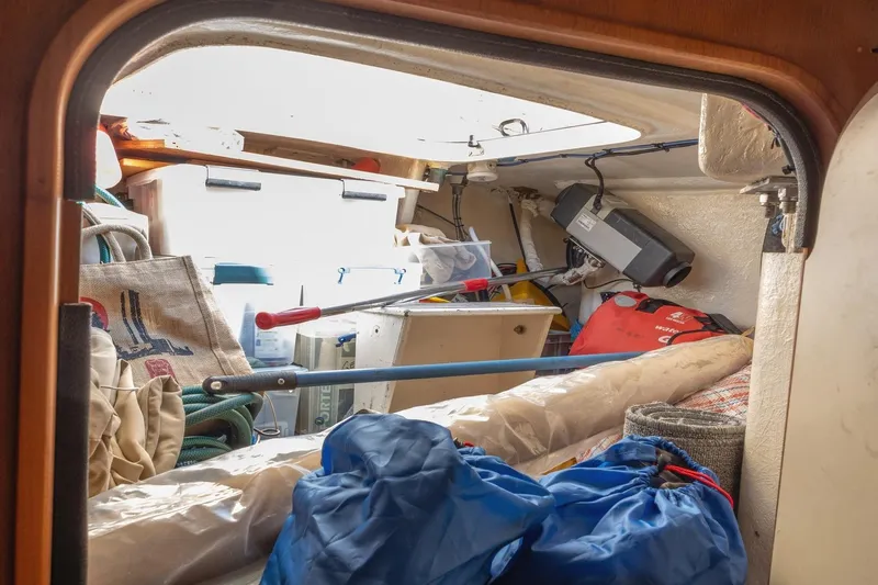  Yacht Photos Pics Interior storage area of 2008 Island Packet 465 sailboat, filled with various equipment and supplies.