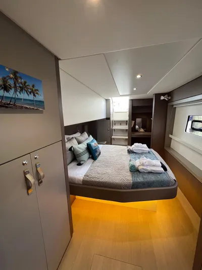  Yacht Photos Pics Luxurious cabin interior of 2020 Bali 4.8 yacht with cozy bed and modern decor.