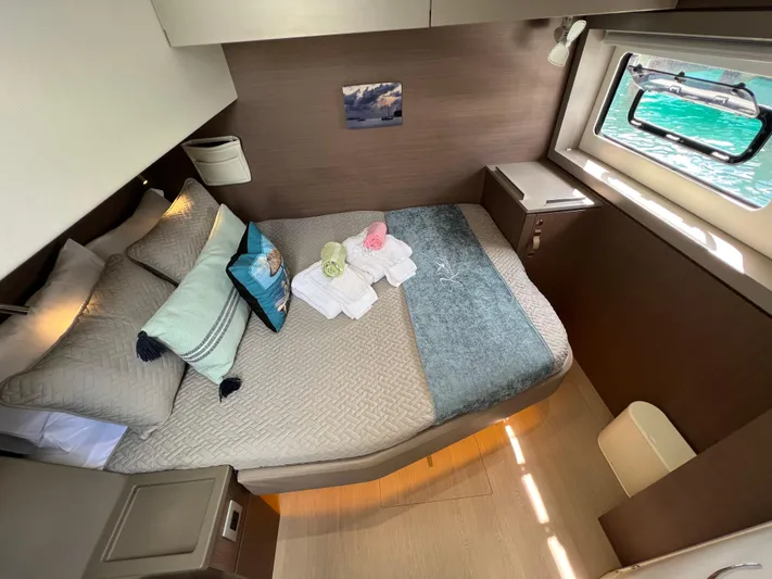  Yacht Photos Pics Cozy cabin interior of 2020 Bali 4.8 yacht with bed and window view.