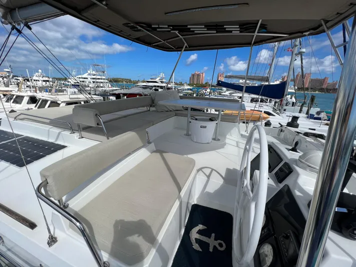  Yacht Photos Pics Spacious deck of 2020 Bali 4.8 catamaran in marina, featuring seating and steering wheel.