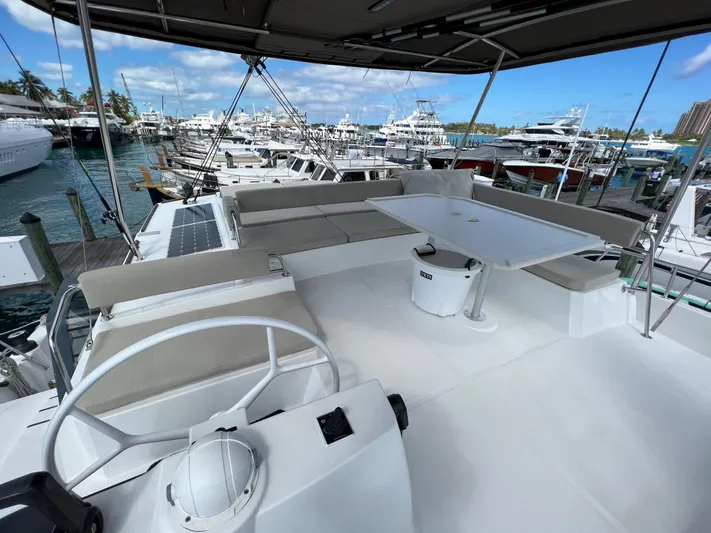  Yacht Photos Pics Bali 4.8 catamaran deck, 2020 model, featuring seating and table, docked at marina.