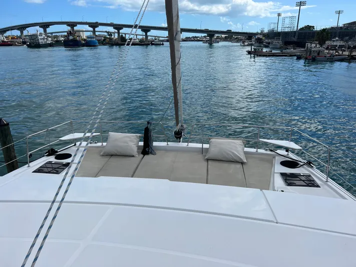  Yacht Photos Pics 2020 Bali 4.8 catamaran with spacious deck, docked in a marina with bridge view.