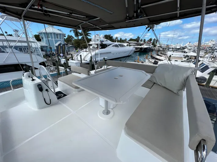  Yacht Photos Pics Bali 4.8 yacht deck with seating and table, docked at marina, 2020 model.