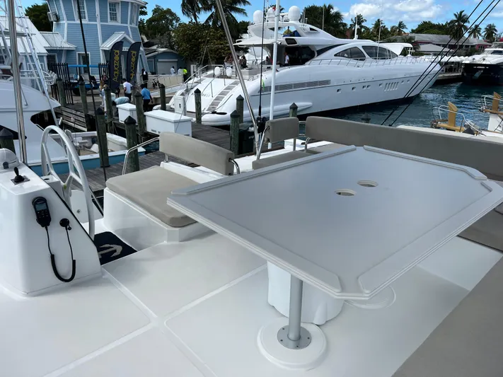  Yacht Photos Pics Bali 4.8 catamaran deck with seating and table, docked at marina, 2020 model.