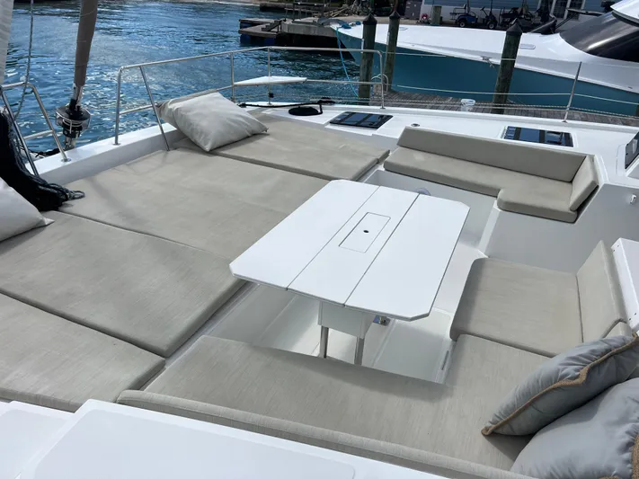  Yacht Photos Pics Luxurious seating area on a 2020 Bali 4.8 yacht with cushions and table.