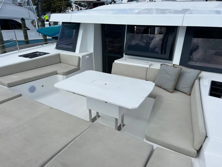  Yacht Photos Pics Spacious seating area on a 2020 Bali 4.8 catamaran with a central table.