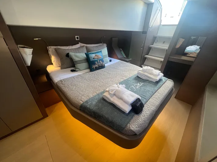  Yacht Photos Pics Luxurious cabin interior of 2020 Bali 4.8 yacht with cozy bed and modern decor.