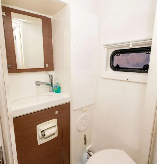  Yacht Photos Pics Compact bathroom in a 2020 Bali 4.8 model, featuring a sink, mirror, and window.