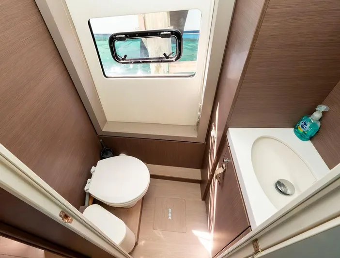 Yacht Photos Pics Compact bathroom in 2020 Bali 4.8 yacht with window, toilet, and sink.