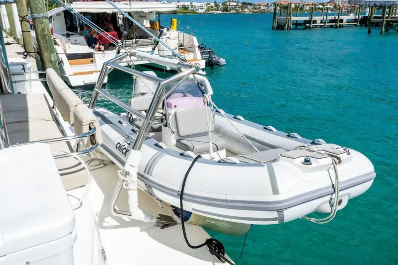  Yacht Photos Pics Inflatable boat docked on a Bali 4.8 catamaran, 2020 model, in clear turquoise water.