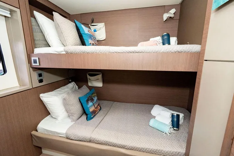  Yacht Photos Pics Bunk beds in a 2020 Bali 4.8 yacht cabin, featuring cozy bedding and modern design.