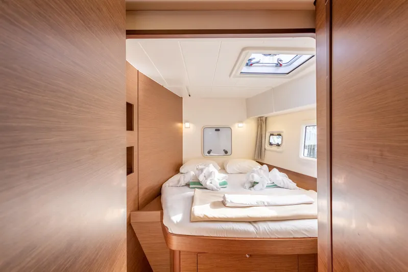 Arctic Fantasy II Yacht Photos Pics Luxurious cabin interior of 2020 Lagoon 42 catamaran with cozy bed and natural light.