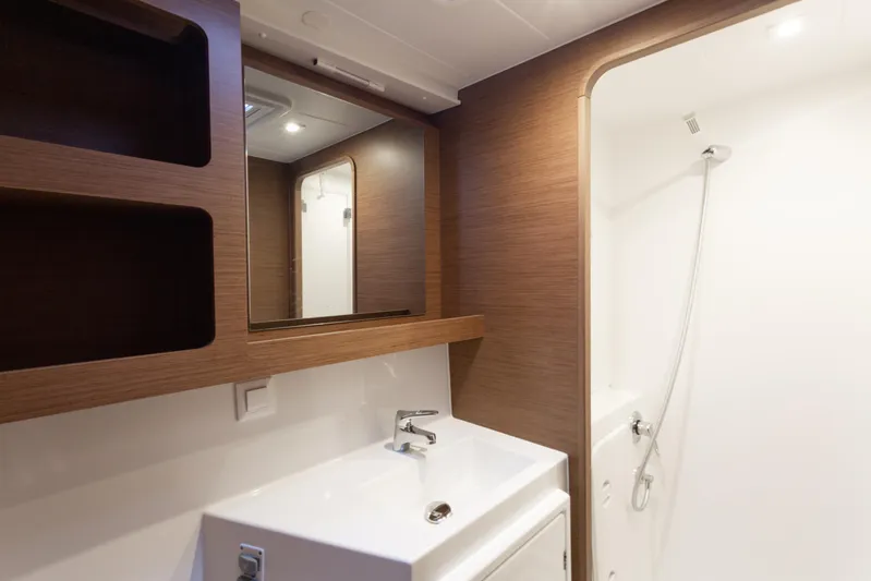 Arctic Fantasy II Yacht Photos Pics Modern bathroom interior on 2020 Lagoon 42 yacht, featuring sleek sink and shower area.