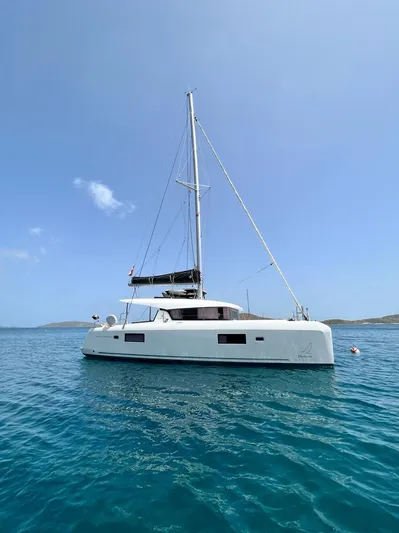 Arctic Fantasy II Yacht Photos Pics 2020 Lagoon 42 catamaran sailing on calm blue waters under a clear sky.