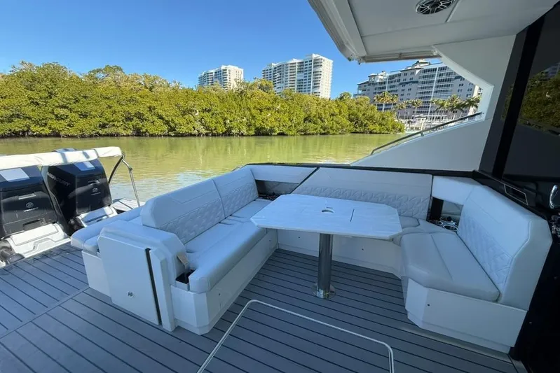  Yacht Photos Pics 2022 Formula 500 Super Sport Crossover yacht with luxurious seating and scenic waterfront view.